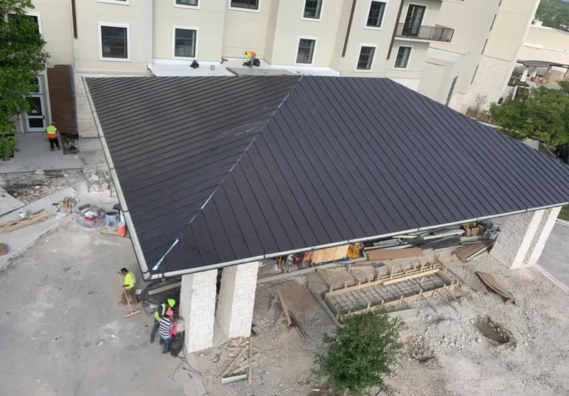 Metal roofing installation team working on a commercial building in Tehachapi